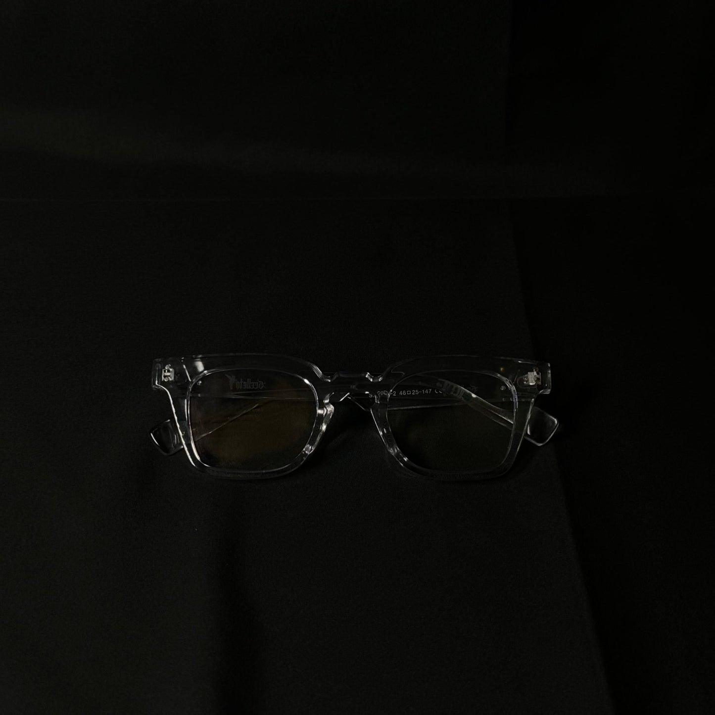 Clear eyeglasses on a black background