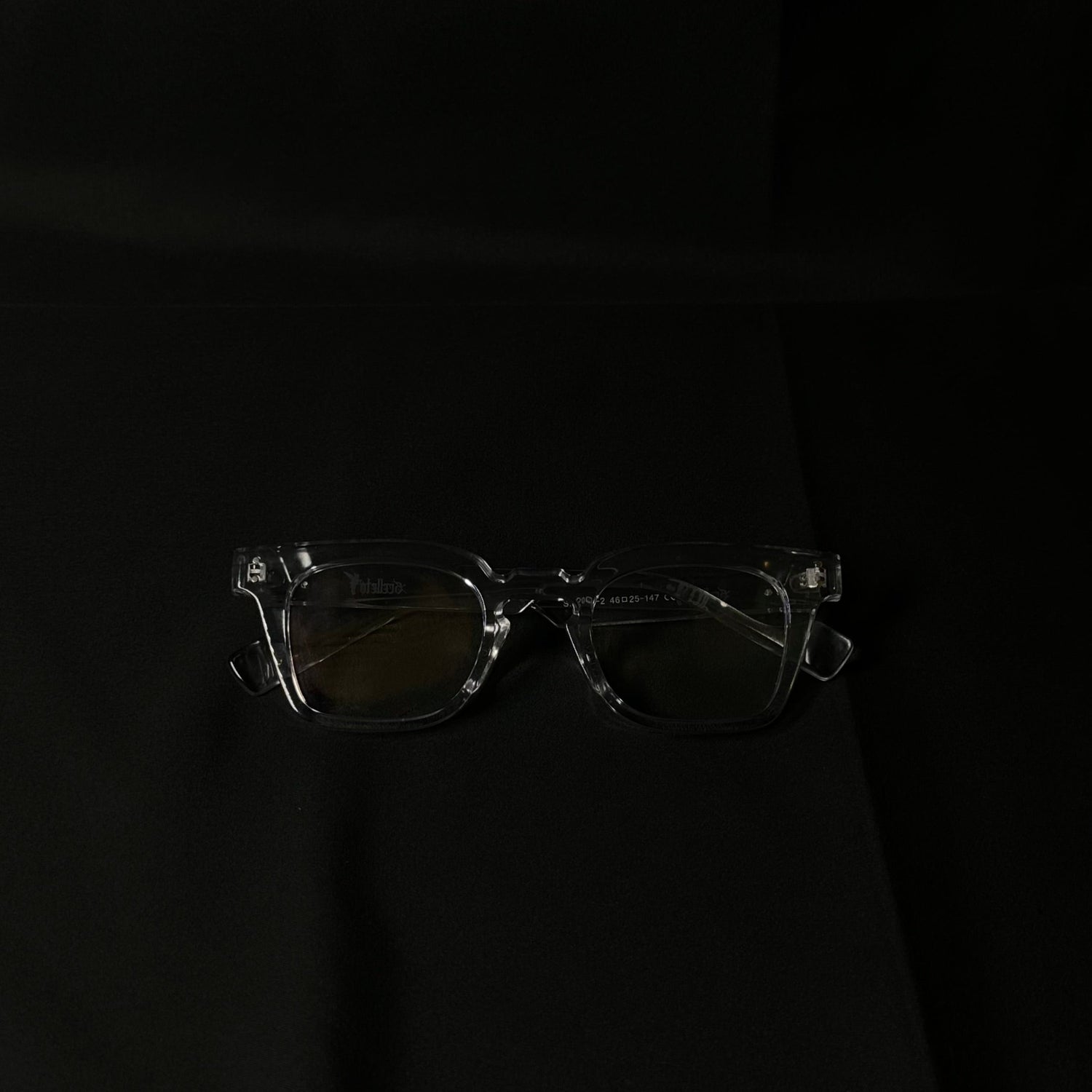 Clear eyeglasses on a black background